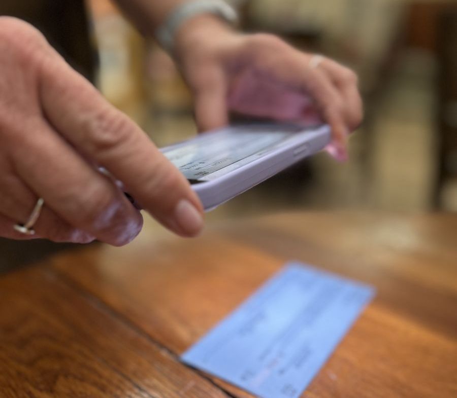 person taking a picture of a check