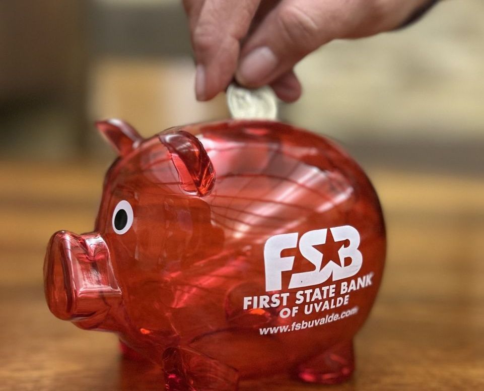 woman putting change in piggy bank